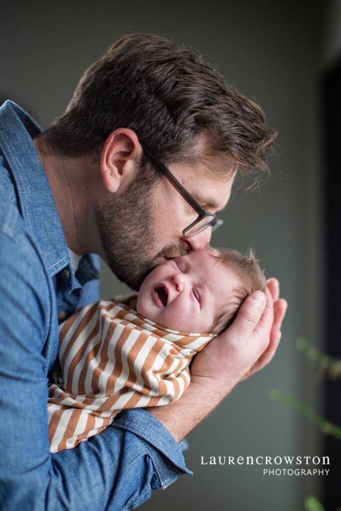 Dad holding newborn baby