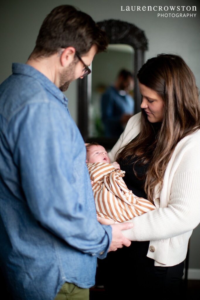 parents with newborn baby during their photoshoot at home